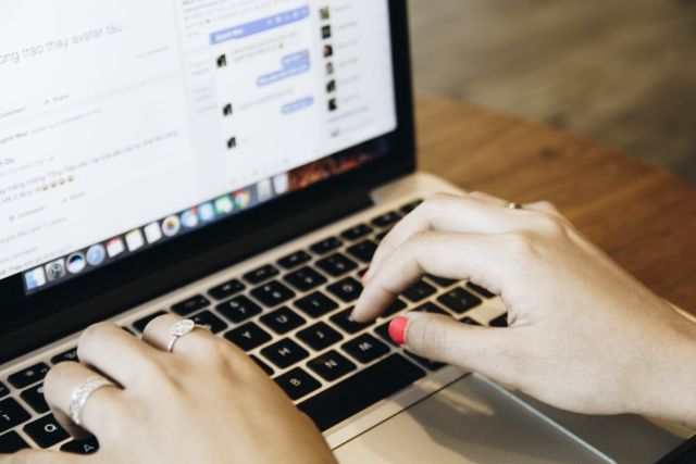 woman typing and browsing through an online shop