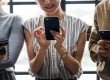 Woman with smartphone looking happy