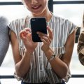 Woman with smartphone looking happy